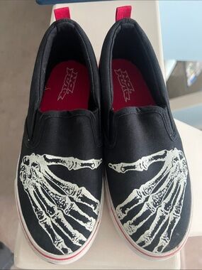 Black Slip-On Sneakers with a Glow In the Dark White Skeleton Hand Graphic